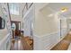 Bright entryway with staircase and hardwood floors leading to a hallway with detailed trim at 1961 Luke Edwards Rd, Dacula, GA 30019