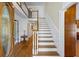 Open foyer featuring hardwood floors, a staircase, and an entry door with sidelight windows at 1961 Luke Edwards Rd, Dacula, GA 30019