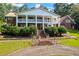 Charming two-story brick home with a grand entrance, featuring white columns and a beautiful brick staircase at 1961 Luke Edwards Rd, Dacula, GA 30019