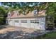 Spacious four-car garage featuring multiple bays and an exterior staircase, perfect for car enthusiasts or extra storage at 1961 Luke Edwards Rd, Dacula, GA 30019