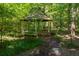 Outdoor gazebo surrounded by trees and grass at 1961 Luke Edwards Rd, Dacula, GA 30019