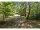 Exterior pathway through the trees at 1961 Luke Edwards Rd, Dacula, GA 30019