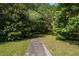 Tree lined path on lushly vegetated grounds at 1961 Luke Edwards Rd, Dacula, GA 30019