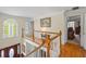 Hallway overlooking the main entrance with hardwood floors and a stained-glass window at 1961 Luke Edwards Rd, Dacula, GA 30019