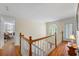 Hallway with wood floors, white walls, and stained-glass window at 1961 Luke Edwards Rd, Dacula, GA 30019