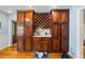 Cherry wood cabinets offer plenty of storage including a dedicated spot for wine at 1961 Luke Edwards Rd, Dacula, GA 30019