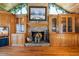 Inviting living room featuring a stone fireplace and custom wood cabinets and stained-glass window at 1961 Luke Edwards Rd, Dacula, GA 30019
