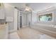 Spacious bathroom with jacuzzi tub, vanity, and lovely stained-glass window at 1961 Luke Edwards Rd, Dacula, GA 30019