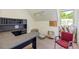 Attic office space featuring a desk, chair, and natural light from a window at 1961 Luke Edwards Rd, Dacula, GA 30019