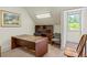 Attic office space featuring a built-in bookcase, office furniture, and natural light from a window at 1961 Luke Edwards Rd, Dacula, GA 30019