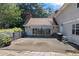 Exterior shot of patio with a grill and flower pot, adjacent to home and swimming pool at 1961 Luke Edwards Rd, Dacula, GA 30019