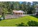 Backyard pool and deck featuring a pool house with brick accents and an attached deck, ideal for summer fun at 1961 Luke Edwards Rd, Dacula, GA 30019