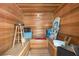 The traditional sauna room has wood paneling and features built-in benches at 1961 Luke Edwards Rd, Dacula, GA 30019