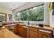 The wet bar features wood cabinetry and a large window with a view to the outdoors at 1961 Luke Edwards Rd, Dacula, GA 30019