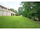 A sprawling backyard with lush lawn, mature trees and a shed behind the home at 2302 Springside Way, Decatur, GA 30032