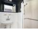 Simple bathroom featuring walk-in shower with safety bars and pedestal sink at 2302 Springside Way, Decatur, GA 30032