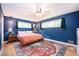 Stylish bedroom with blue walls, hardwood floors, and a plush bed at 2302 Springside Way, Decatur, GA 30032