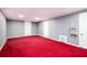 Bedroom with light gray walls, bright red carpeting, and two white doors at 2302 Springside Way, Decatur, GA 30032