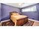 Cozy bedroom features purple walls and a beautifully carved wooden bed frame at 2302 Springside Way, Decatur, GA 30032