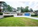 Charming one-story home with a blue garage door and a well-maintained front lawn and a white brick exterior at 2302 Springside Way, Decatur, GA 30032