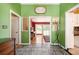 Bright foyer with beautiful tile flooring, complemented by green walls and views of the living spaces beyond at 2302 Springside Way, Decatur, GA 30032