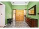 Green foyer with a large wooden double-door and stone tile flooring at 2302 Springside Way, Decatur, GA 30032