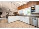 Well-lit kitchen featuring white cabinets, stainless steel appliances, and tile flooring at 2302 Springside Way, Decatur, GA 30032