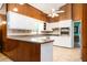 Spacious kitchen featuring white cabinets, stainless steel oven, and warm wood paneling at 2302 Springside Way, Decatur, GA 30032