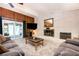 Bright living room with brick fireplace, modern entertainment system, and sliding glass doors at 2302 Springside Way, Decatur, GA 30032