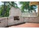 Outdoor brick fireplace on a patio, offering a cozy space for gatherings and relaxation at 2302 Springside Way, Decatur, GA 30032