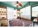 Bright sunroom with large windows, neutral toned sofa, and hardwood floors at 2302 Springside Way, Decatur, GA 30032