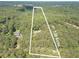 Aerial view of a vast 7.09-acre parcel, offering privacy and surrounded by dense woods at 4120 Grady Smith Rd, Loganville, GA 30052