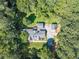 Aerial view of a home with mature trees surrounding the home and garage at 4120 Grady Smith Rd, Loganville, GA 30052