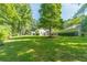 Expansive backyard with mature trees, partial fencing, and view of the home at 4120 Grady Smith Rd, Loganville, GA 30052