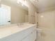 Bathroom featuring a vanity with white cabinets, a large mirror, and a shower-tub combo at 4120 Grady Smith Rd, Loganville, GA 30052