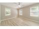 Bright bedroom with neutral paint, ceiling fan, and three windows letting in natural light at 4120 Grady Smith Rd, Loganville, GA 30052