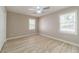 Bright bedroom with neutral paint, ceiling fan, and two windows letting in natural light at 4120 Grady Smith Rd, Loganville, GA 30052