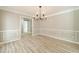 Spacious dining room with chair rail molding and neutral paint at 4120 Grady Smith Rd, Loganville, GA 30052