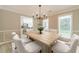 Inviting dining room with a modern light fixture and a wooden table at 4120 Grady Smith Rd, Loganville, GA 30052