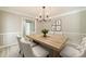 Inviting dining room with a modern light fixture and a wooden table at 4120 Grady Smith Rd, Loganville, GA 30052