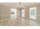 Dining room showcasing a modern chandelier and chair rail molding at 4120 Grady Smith Rd, Loganville, GA 30052