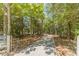 Private driveway leading to the residence surrounded by wooded landscape at 4120 Grady Smith Rd, Loganville, GA 30052