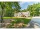 Exterior view of the house with lots of mature trees and a long driveway at 4120 Grady Smith Rd, Loganville, GA 30052