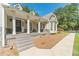 Covered front porch with stone accents, columns, and decorative lattice at 4120 Grady Smith Rd, Loganville, GA 30052