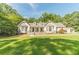 Charming single-story home featuring a symmetrical facade, bay windows, and a well-manicured lawn at 4120 Grady Smith Rd, Loganville, GA 30052