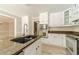 Modern kitchen featuring a granite island, white cabinets, and stainless steel appliances at 4120 Grady Smith Rd, Loganville, GA 30052