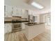 Bright kitchen with stainless steel appliances, island, and light hardwood floors at 4120 Grady Smith Rd, Loganville, GA 30052