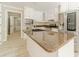 Well-lit kitchen with stainless steel appliances, large island, and ample counter space at 4120 Grady Smith Rd, Loganville, GA 30052
