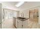 Modern kitchen with a granite island, white cabinets, stainless steel appliances, and hardwood floors at 4120 Grady Smith Rd, Loganville, GA 30052