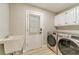 Laundry room featuring a sink, washer and dryer and door to outside at 4120 Grady Smith Rd, Loganville, GA 30052